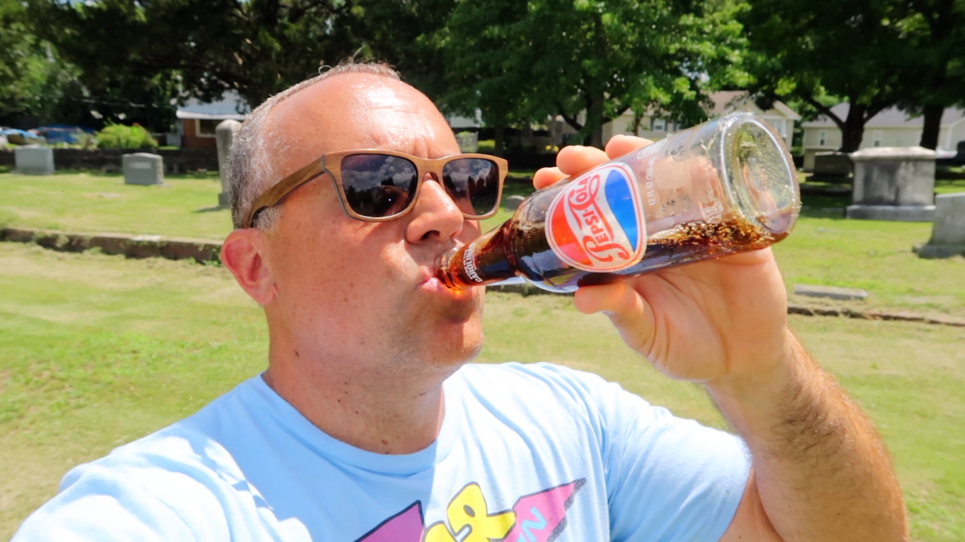 Guy drinking from a Pepsi bottle